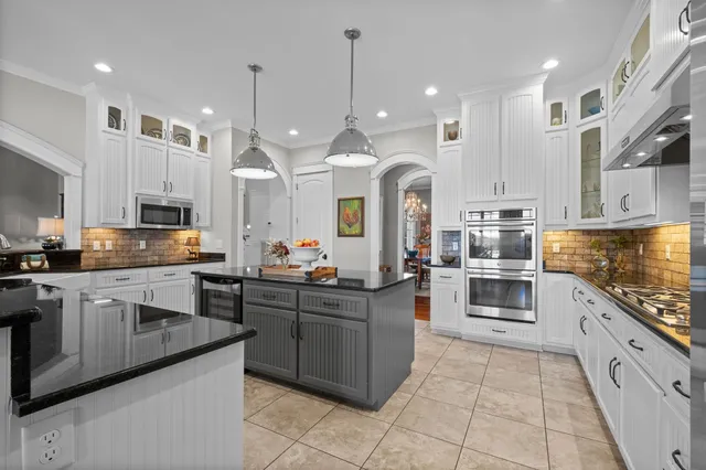 a spacious bathroom with a double vanity sink a mirror and a bathtub