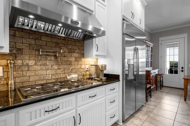 a bathroom with a granite countertop sink a mirror and a shower