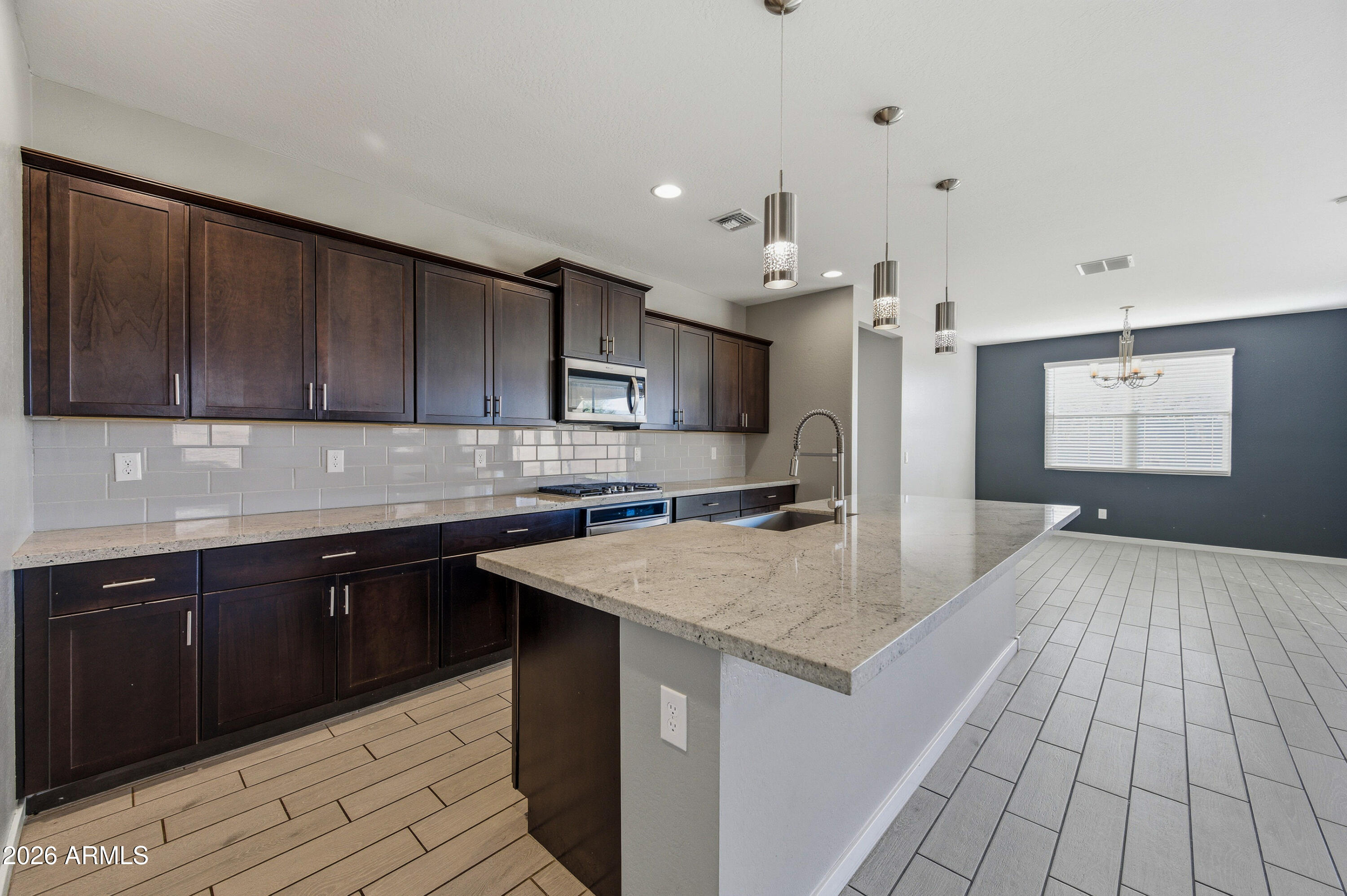 a kitchen with a sink cabinets and wooden floor