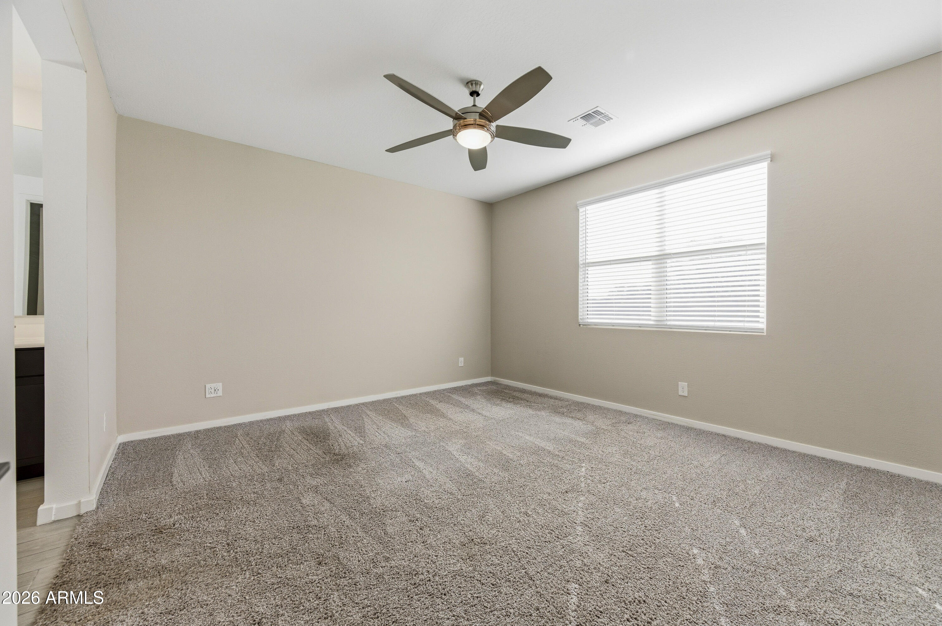 18225 West Pierson Street Goodyear, AZ 85395 - Photo 21 of 39 an empty room with windows and ceiling fan