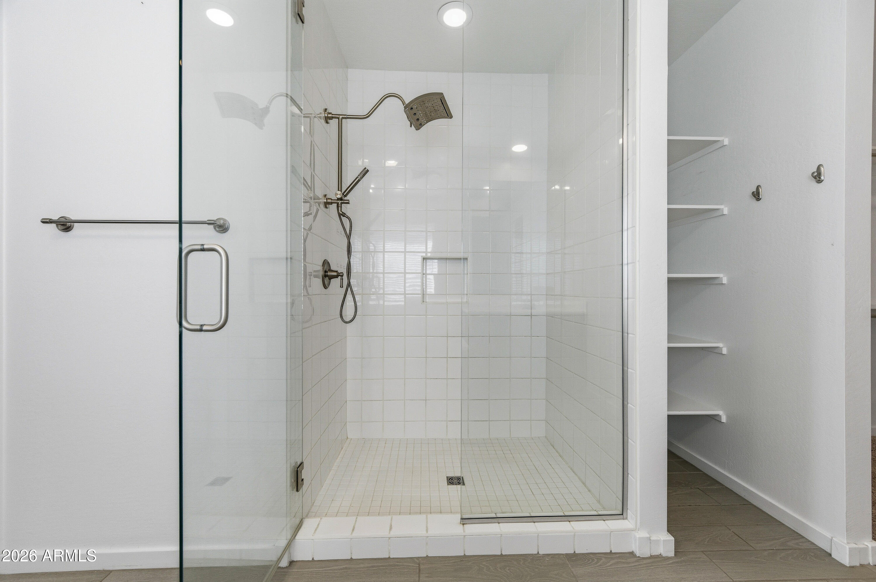 18225 West Pierson Street Goodyear, AZ 85395 - Photo 26 of 39 a bathroom with a glass shower door