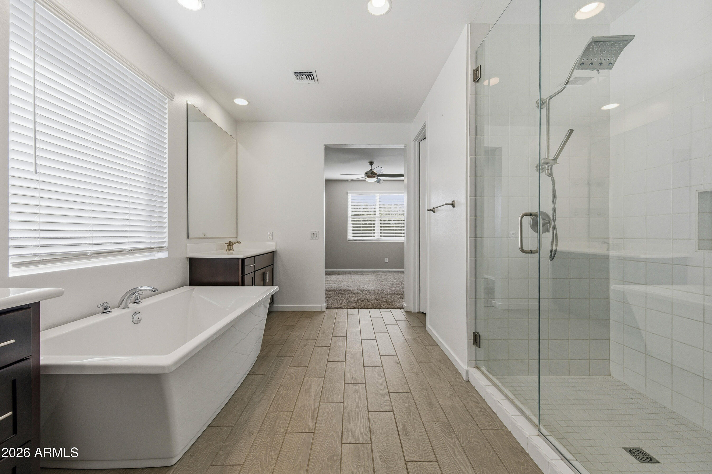 18225 West Pierson Street Goodyear, AZ 85395 - Photo 27 of 39 a bathroom with a bathtub and a shower