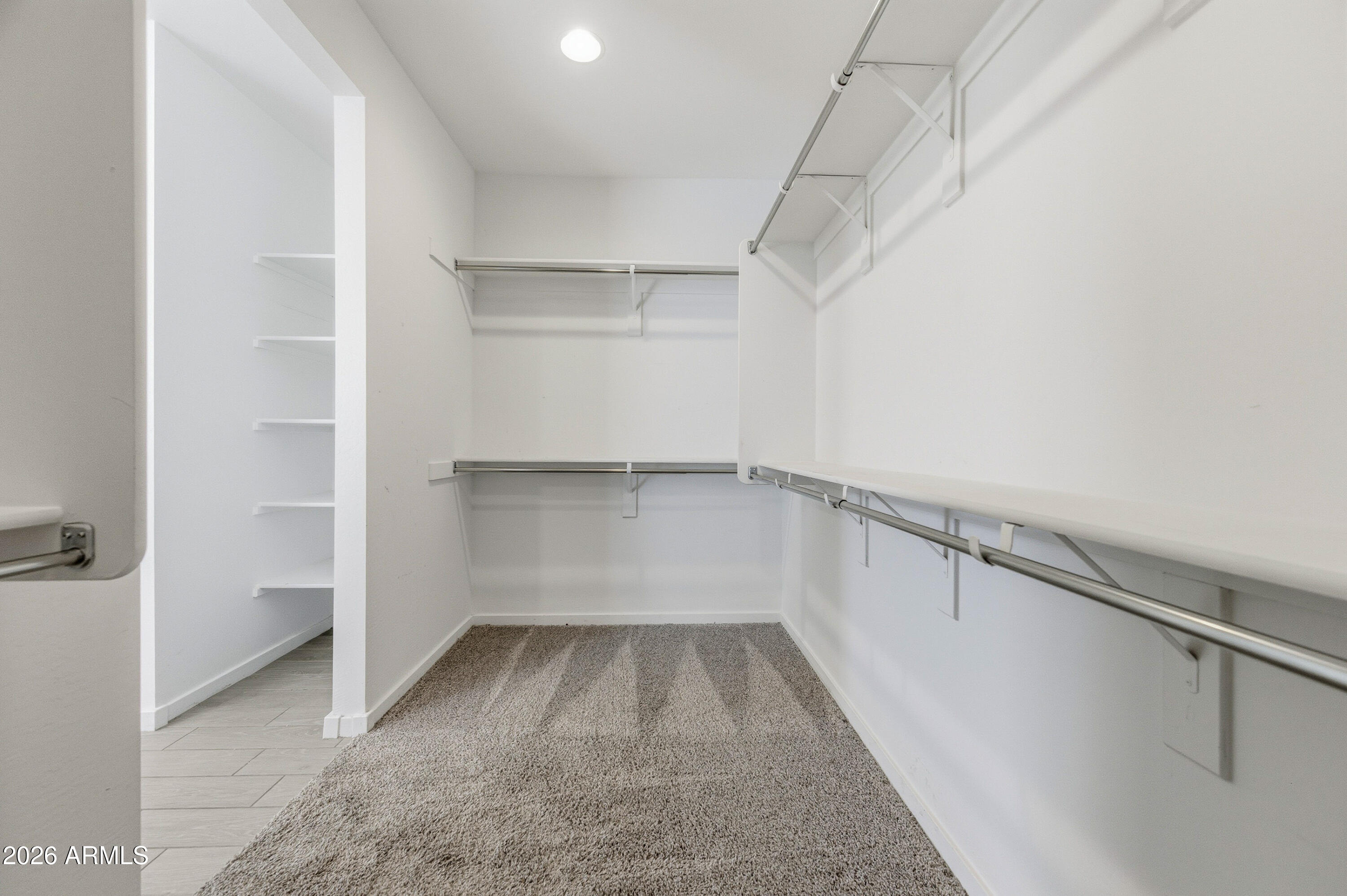 18225 West Pierson Street Goodyear, AZ 85395 - Photo 28 of 39 a view of walk in closet with empty racks