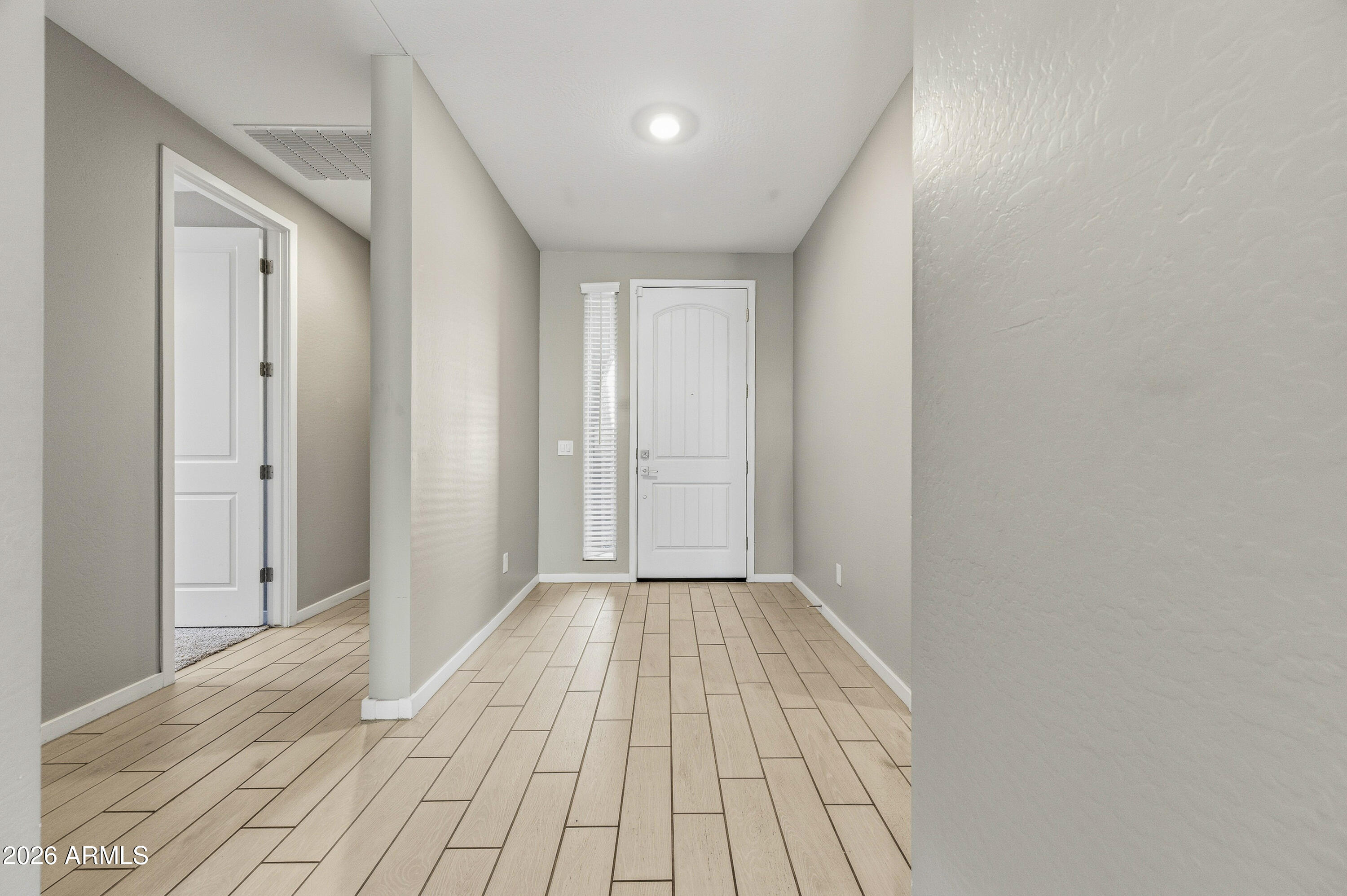 18225 West Pierson Street Goodyear, AZ 85395 - Photo 32 of 39 a view of a hallway with wooden floor