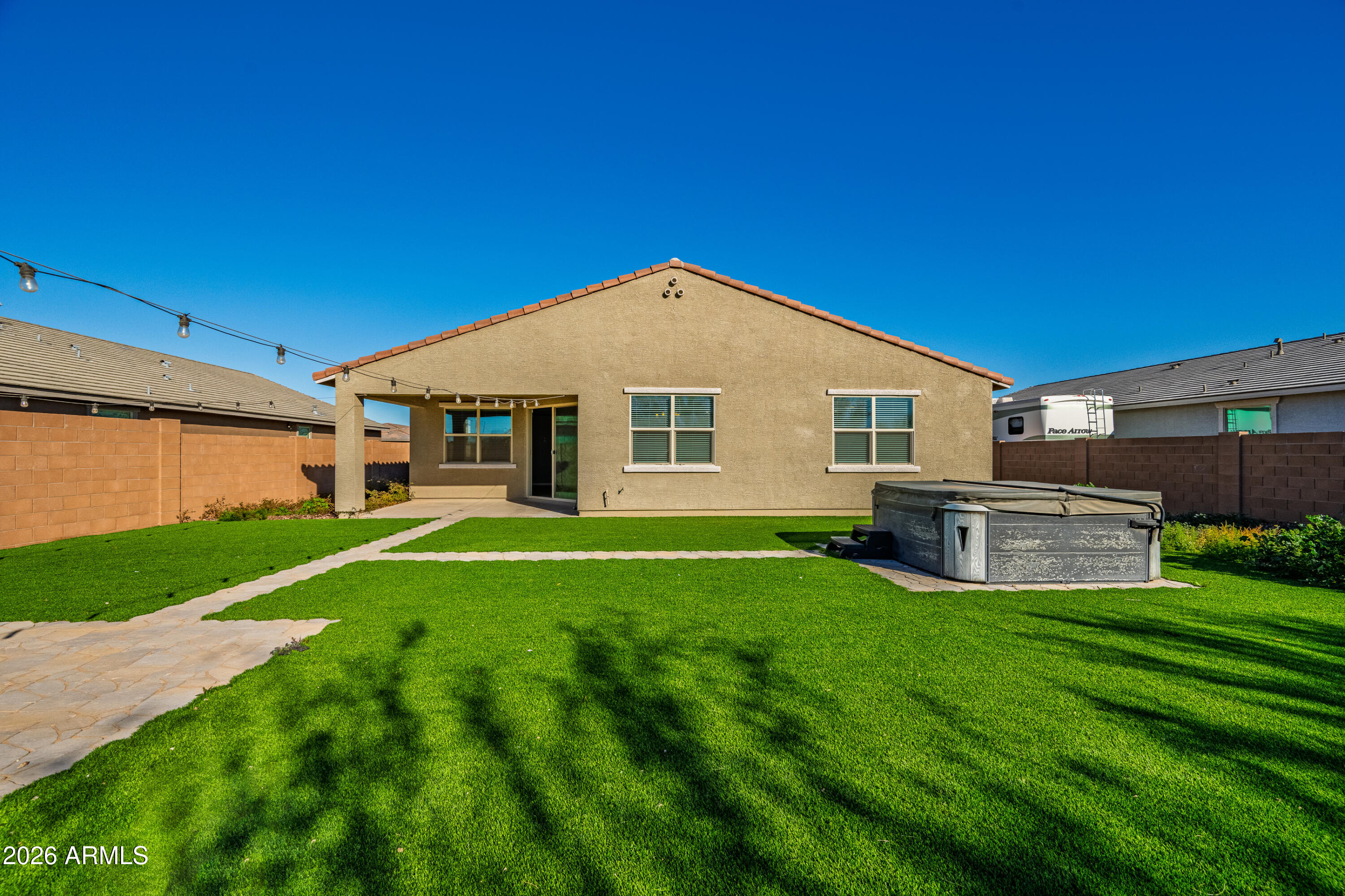 18225 West Pierson Street Goodyear, AZ 85395 - Photo 36 of 39 a backyard of a house with table and chairs