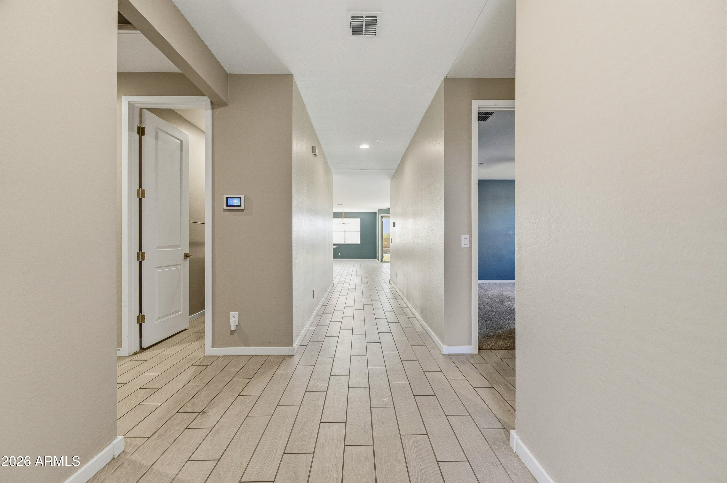18225 West Pierson Street Goodyear, AZ 85395 - Photo 6 of 39 a view of a hallway with wooden floor and staircase