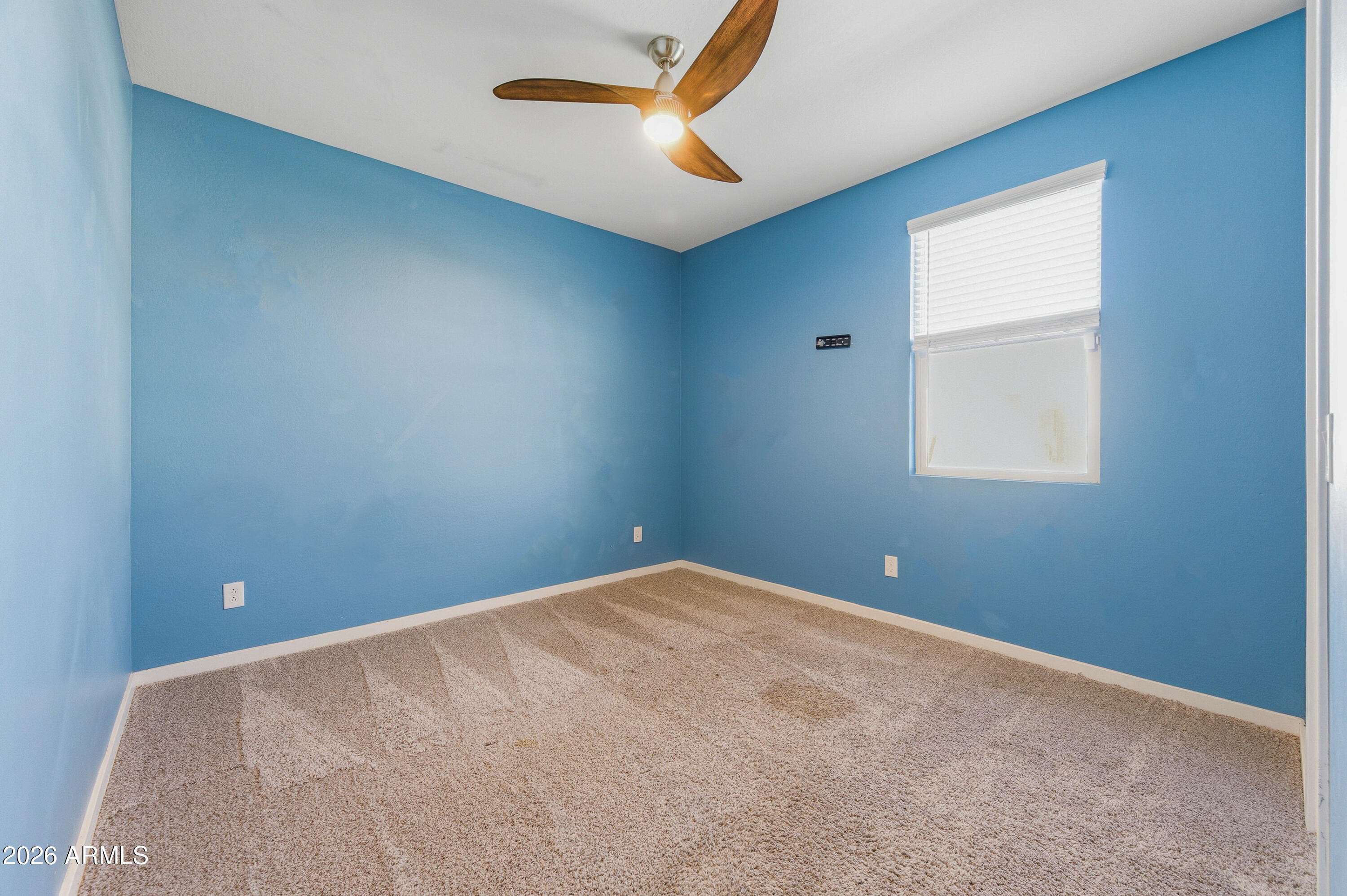 18225 West Pierson Street Goodyear, AZ 85395 - Photo 7 of 39 an empty room with closet and a ceiling fan
