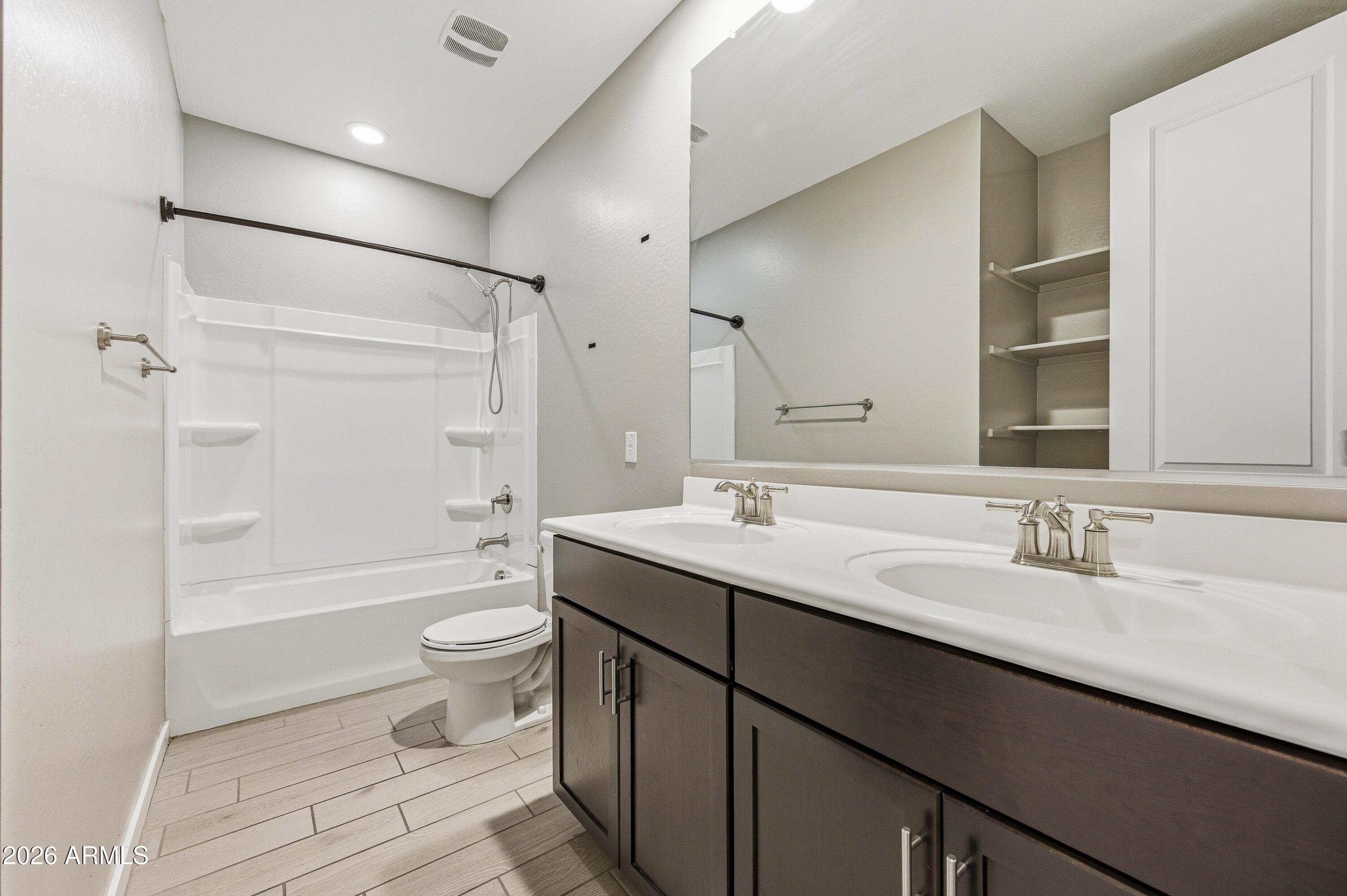 18225 West Pierson Street Goodyear, AZ 85395 - Photo 8 of 39 a bathroom with a granite countertop sink toilet mirror and shower