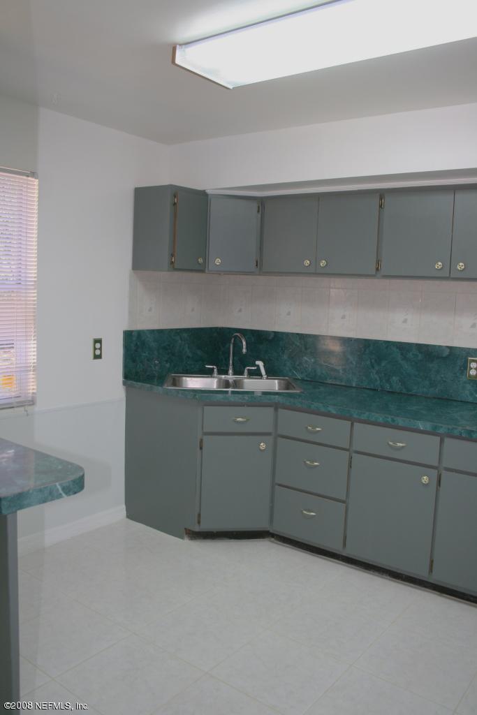 2705 Lorna Road Jacksonville, FL 32211 - Photo 14 of 18 a kitchen with granite countertop white cabinets and a sink
