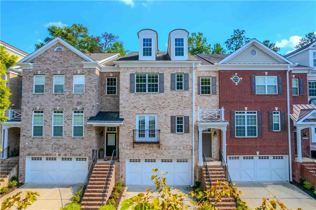 a front view of a house with large windows
