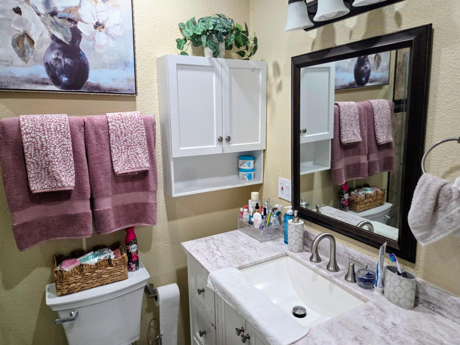 1404 Solar Avenue Modesto, CA 95351 - Photo 16 of 28 a bathroom with a sink mirror and toilet