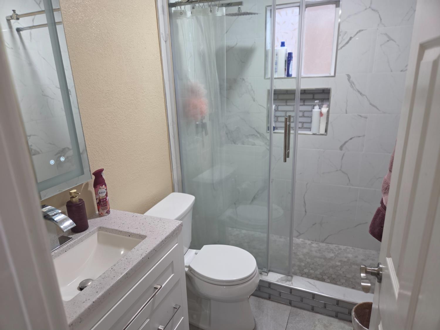 1404 Solar Avenue Modesto, CA 95351 - Photo 18 of 28 a bathroom with a sink toilet and shower