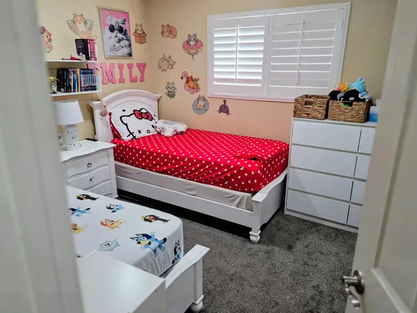 a bedroom with a bed and window