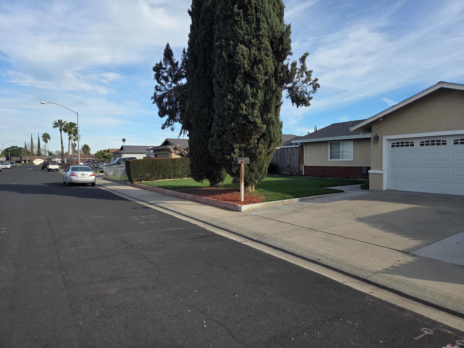 1404 Solar Avenue Modesto, CA 95351 - Photo 3 of 28 a view of a street with a cars parked on the road