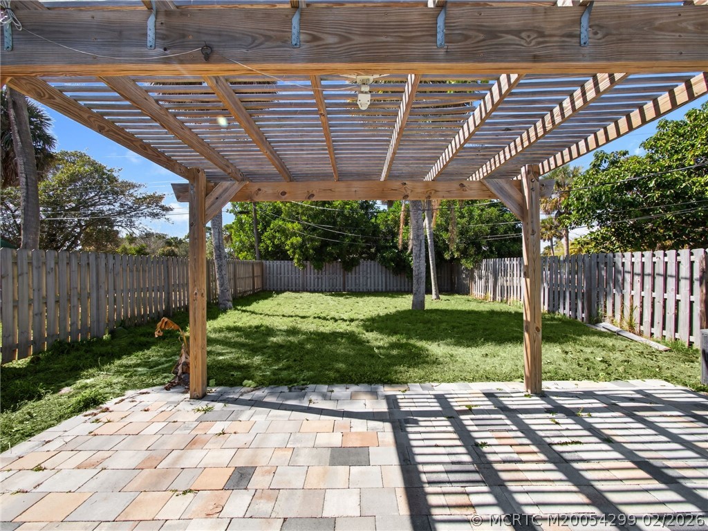 406 Robalo Court Stuart, FL 34996 - Photo 15 of 16 Paver patio with pergula.