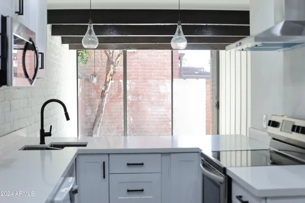 a kitchen with a window a sink and a counter top space