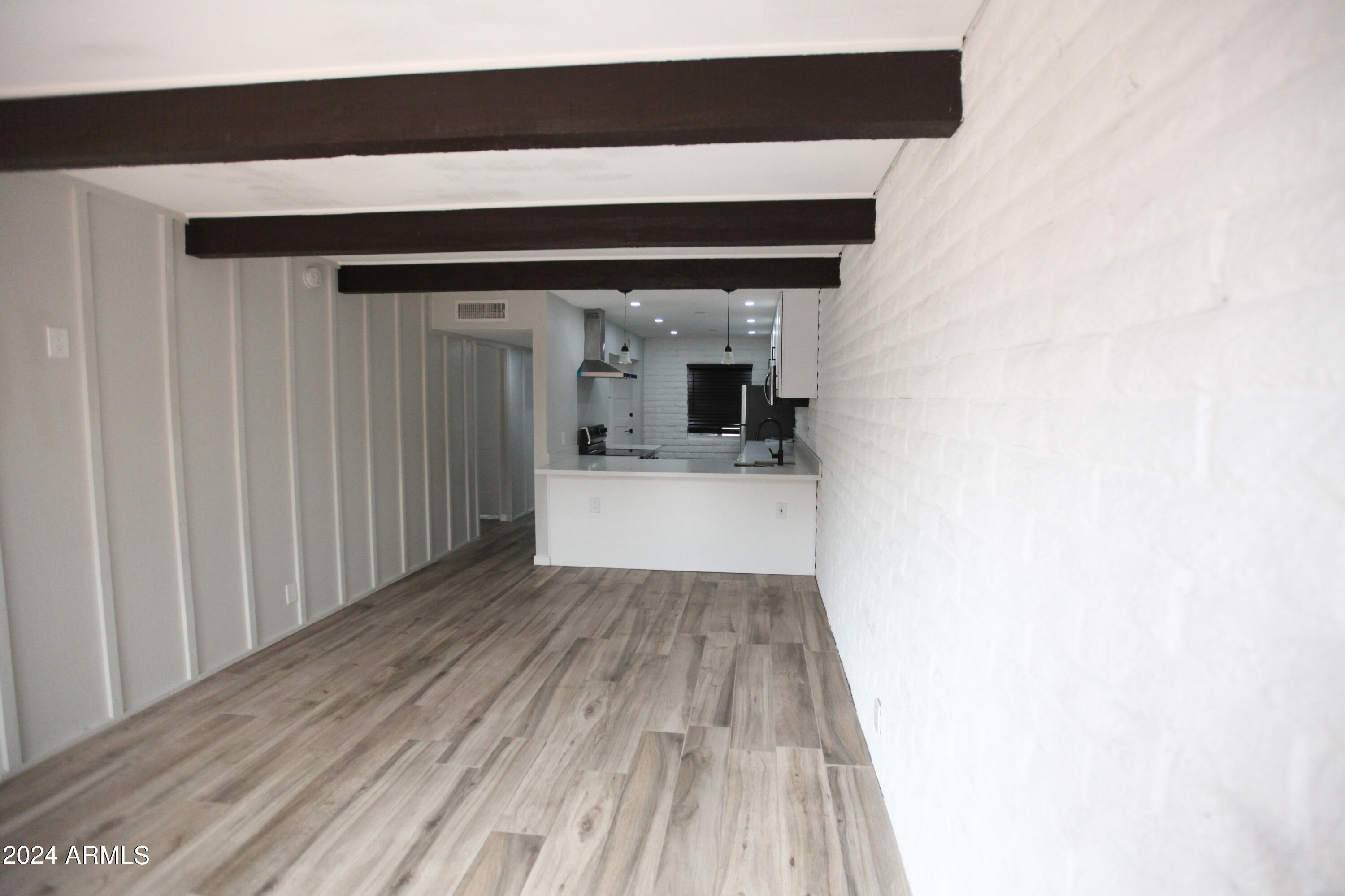3002 North 32nd Street, Unit 19 Phoenix, AZ 85018 - Photo 11 of 26 a view of a hallway with wooden floor and staircase