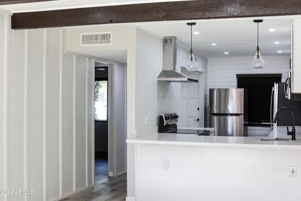 a kitchen with stainless steel appliances kitchen island a refrigerator sink and stove