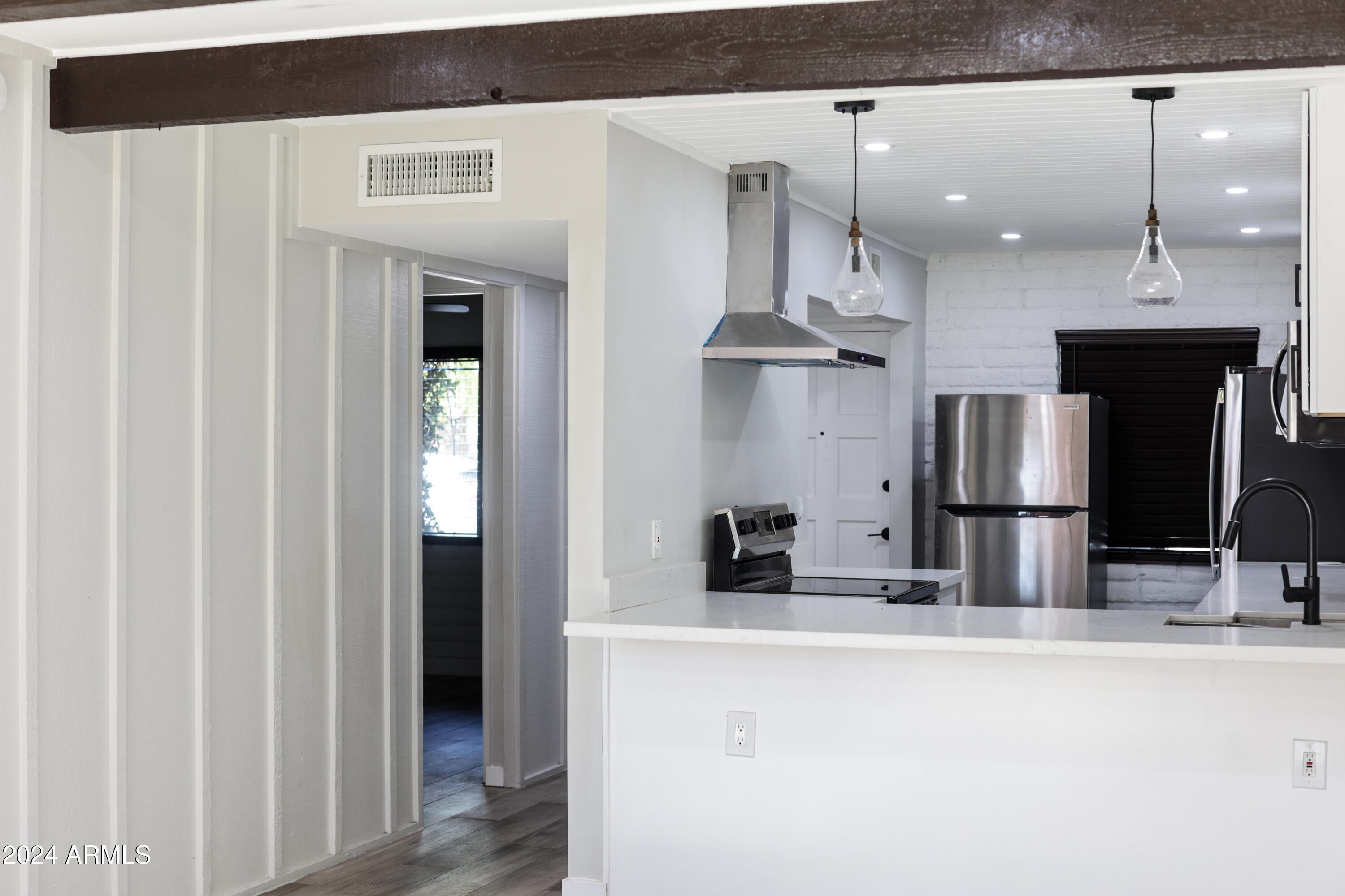 3002 North 32nd Street, Unit 19 Phoenix, AZ 85018 - Photo 13 of 26 a kitchen with stainless steel appliances kitchen island a refrigerator sink and stove