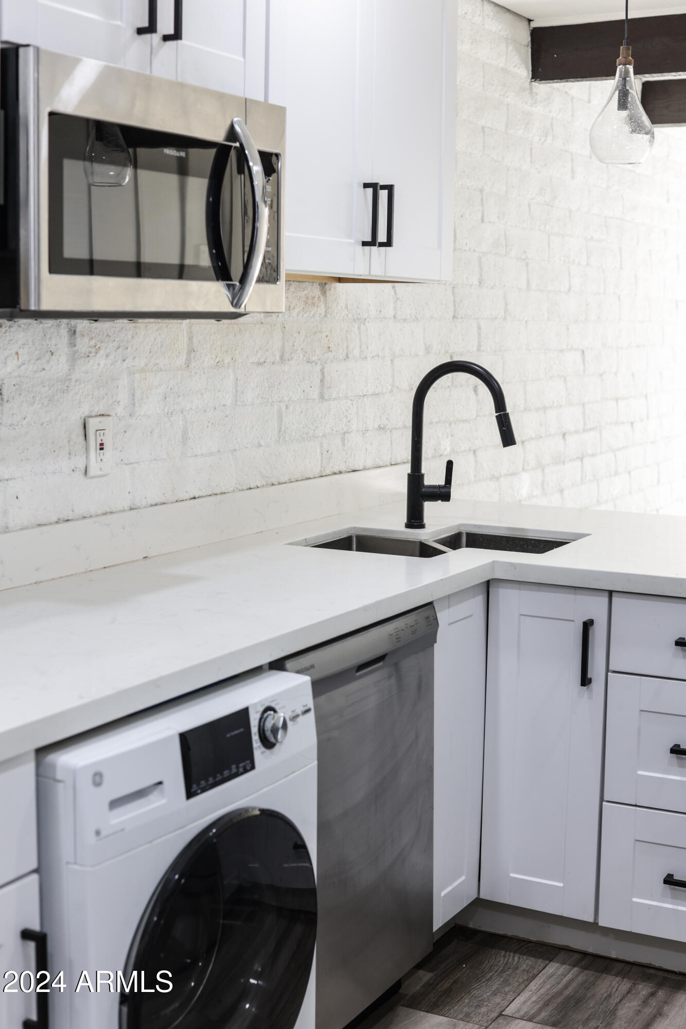 3002 North 32nd Street, Unit 19 Phoenix, AZ 85018 - Photo 14 of 26 a close view of a sink and a washer dryer