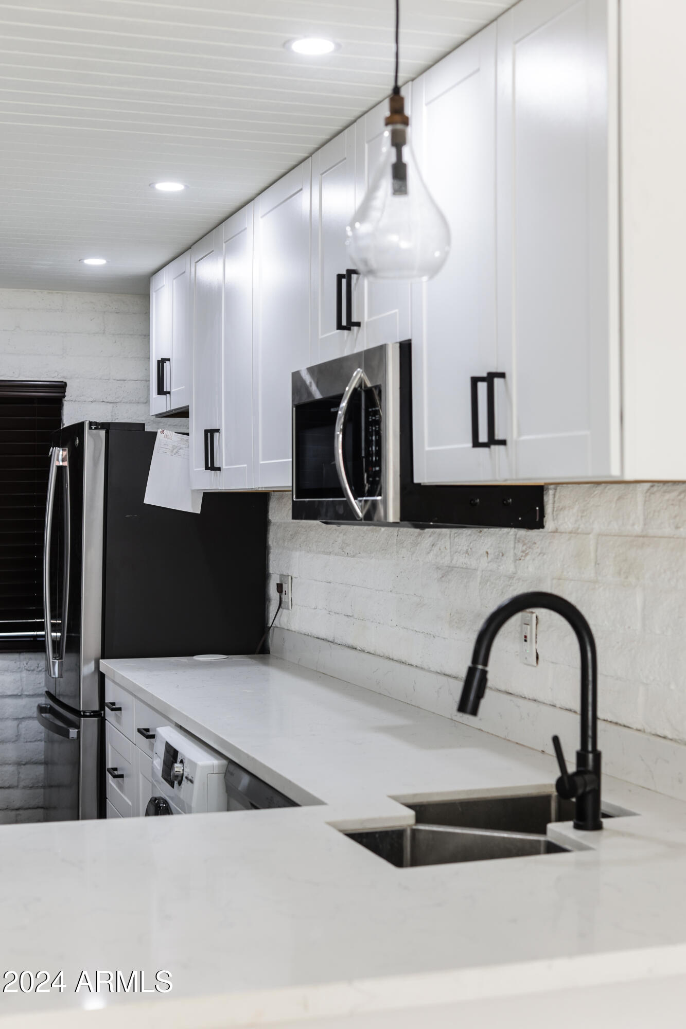 3002 North 32nd Street, Unit 19 Phoenix, AZ 85018 - Photo 16 of 26 a kitchen with kitchen island a counter top a stove and a refrigerator