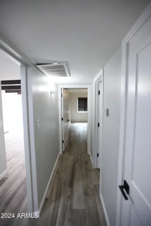 a view of hallway with wooden floor