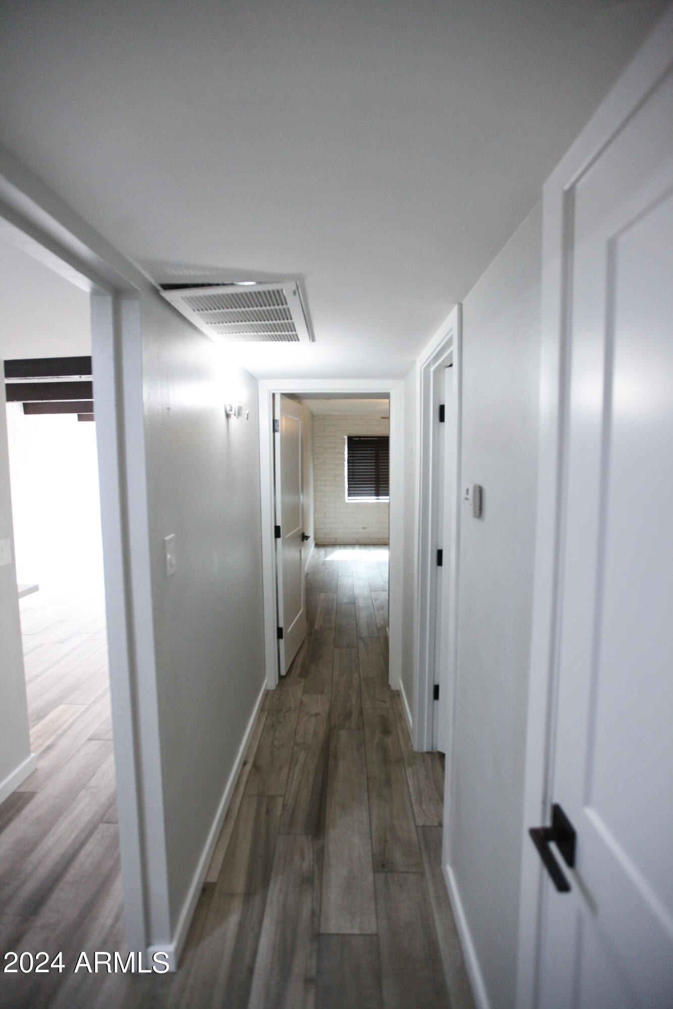 3002 North 32nd Street, Unit 19 Phoenix, AZ 85018 - Photo 19 of 26 a view of hallway with wooden floor