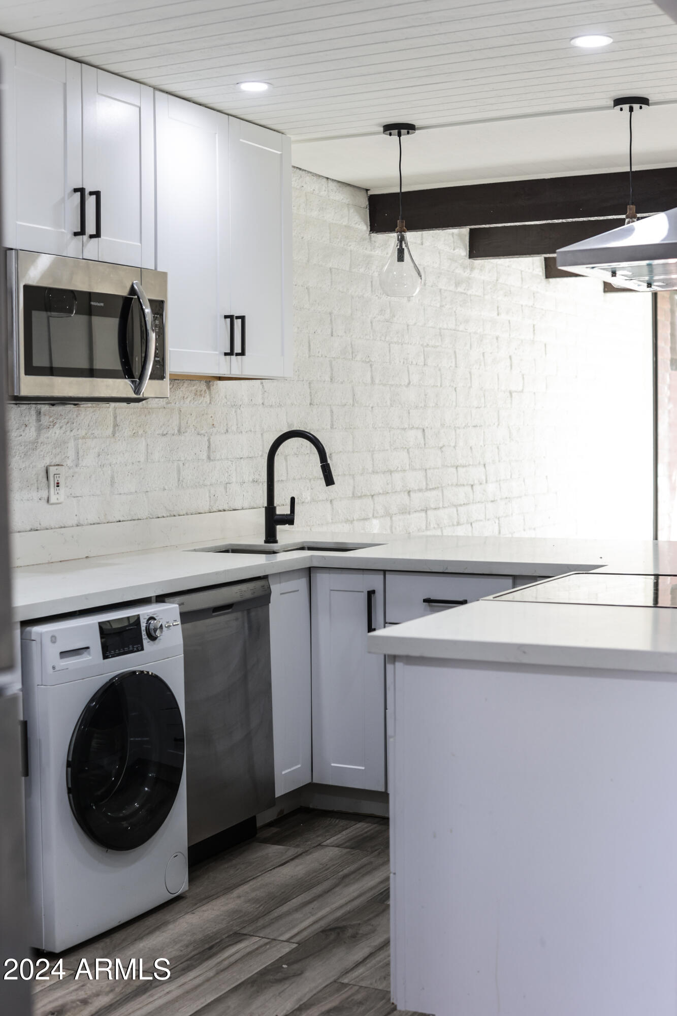 3002 North 32nd Street, Unit 19 Phoenix, AZ 85018 - Photo 9 of 26 a kitchen with a sink a toilet and a mirror