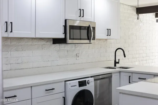 a close view of a sink and a microwave