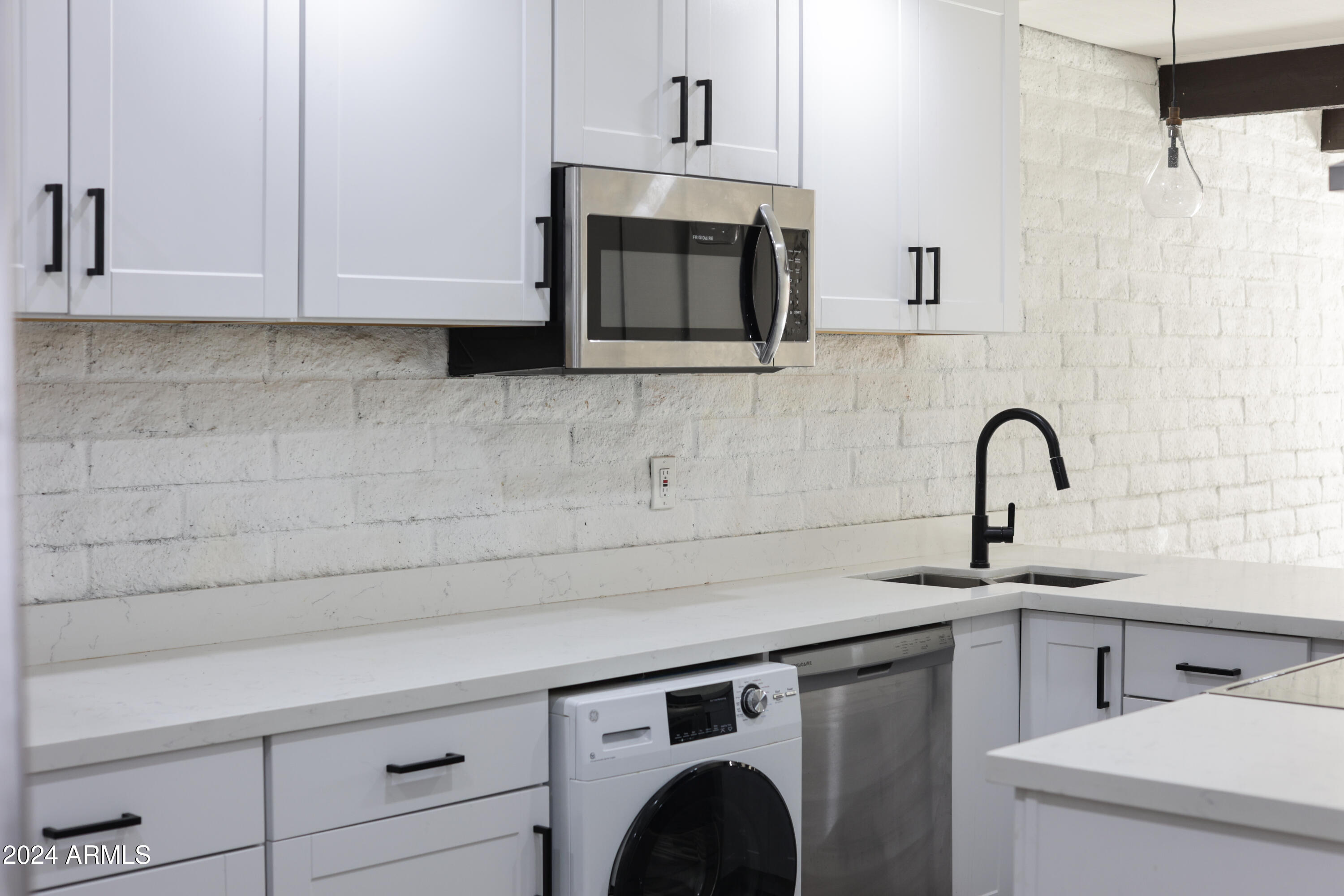 3002 North 32nd Street, Unit 19 Phoenix, AZ 85018 - Photo 10 of 26 a close view of a sink and a microwave