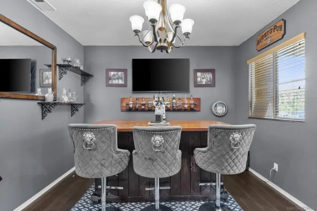 a view of a dining room with furniture wooden floor and chandelier