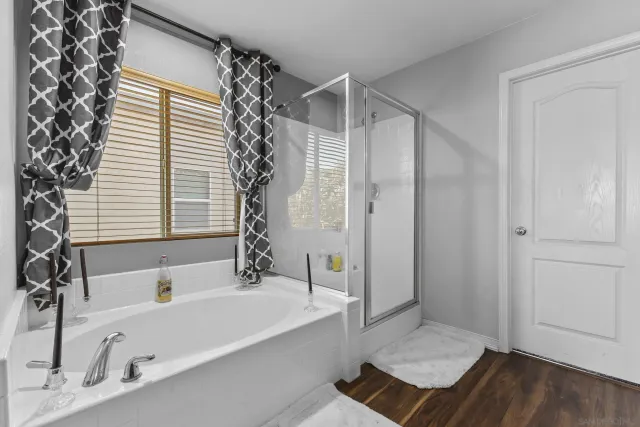 a bathroom with a tub and a shower