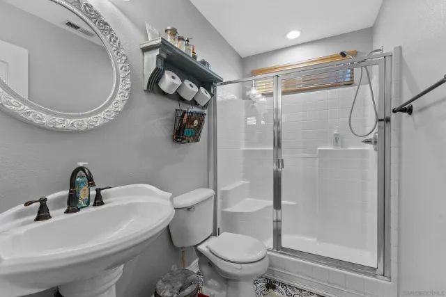 a bathroom with a toilet sink and a shower