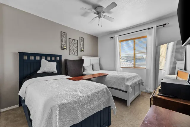 a bedroom with two beds and a chandelier