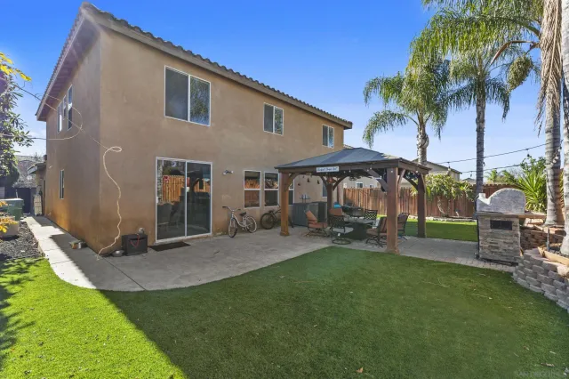 a view of a house with backyard sitting area and garden