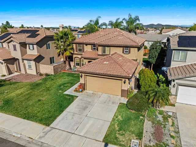 a view of a brick house with wooden fence