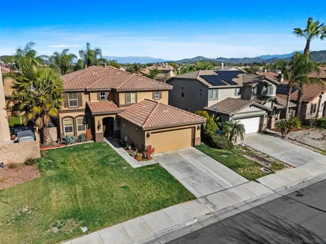 an aerial view of multiple houses with a yard