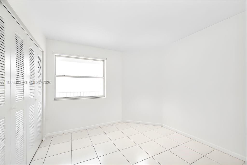 6410 Southwest 112th Place Miami, FL 33173 - Photo 11 of 19 a view of an empty room with a window