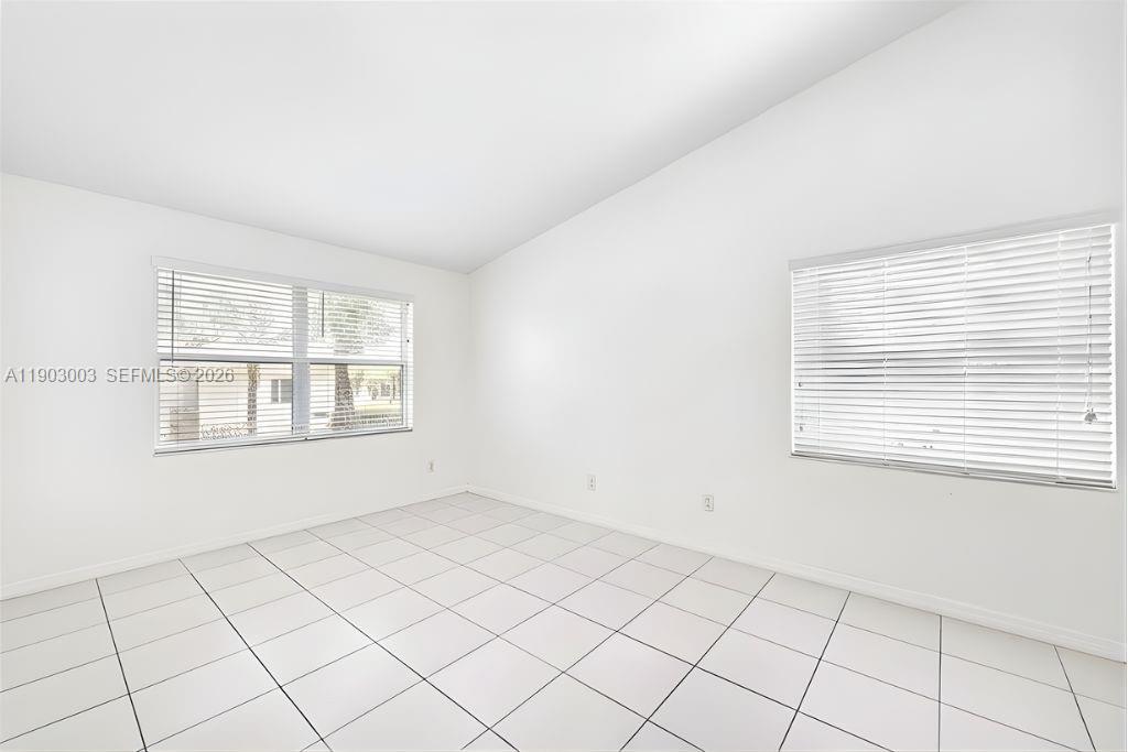 6410 Southwest 112th Place Miami, FL 33173 - Photo 13 of 19 a view of an empty room with a window