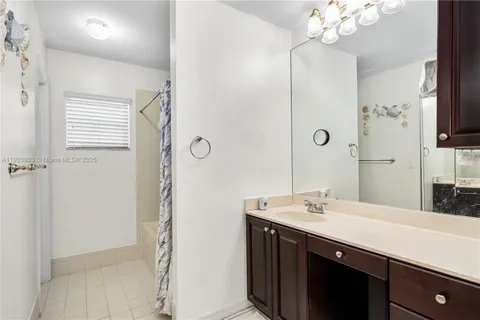 a bathroom with a double vanity sink a mirror and shower