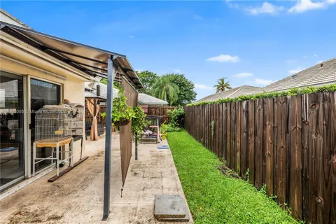 a view of a backyard with sitting area