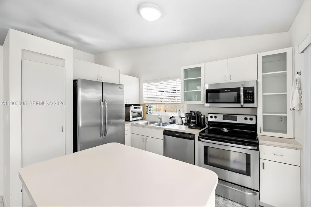 6410 Southwest 112th Place Miami, FL 33173 - Photo 7 of 19 a kitchen with stainless steel appliances a refrigerator stove and microwave