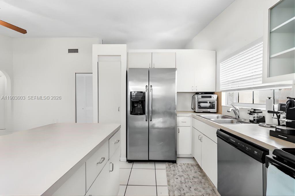 6410 Southwest 112th Place Miami, FL 33173 - Photo 9 of 19 a kitchen with stainless steel appliances a refrigerator sink and microwave