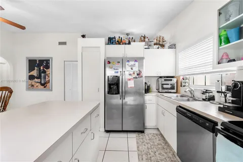 a kitchen with stainless steel appliances a refrigerator sink and microwave