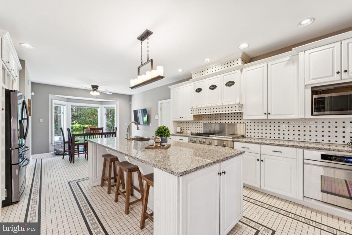 1230 Allview Drive Hampstead, MD 21074 - Photo 10 of 30 a kitchen with stainless steel appliances granite countertop a stove a sink and a refrigerator