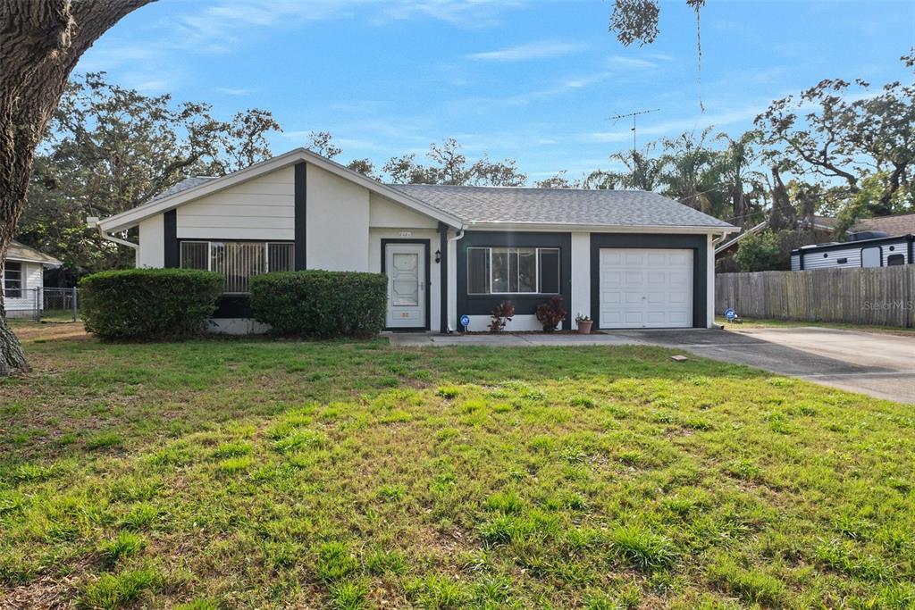 8404 Eldridge Road Spring Hill, FL 34608 - Photo 1 of 1 a front view of a house with a yard