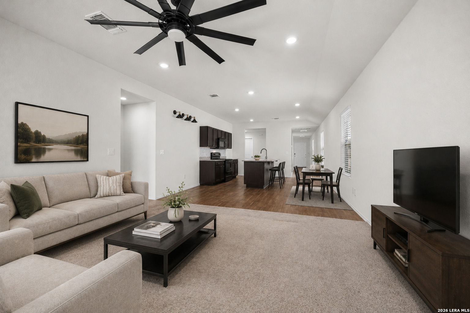 a living room with furniture and a flat screen tv