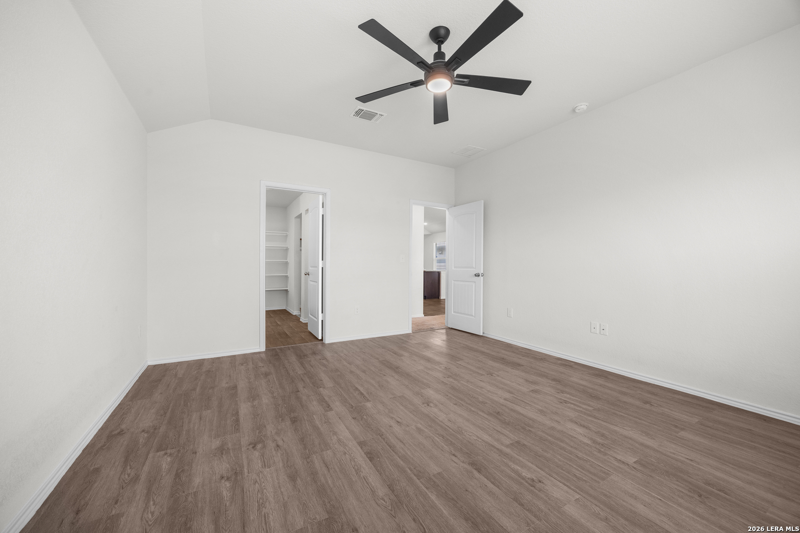 14809 Bajada Road Manor, TX 78653 - Photo 16 of 30 an empty room with wooden floor and ceiling fan