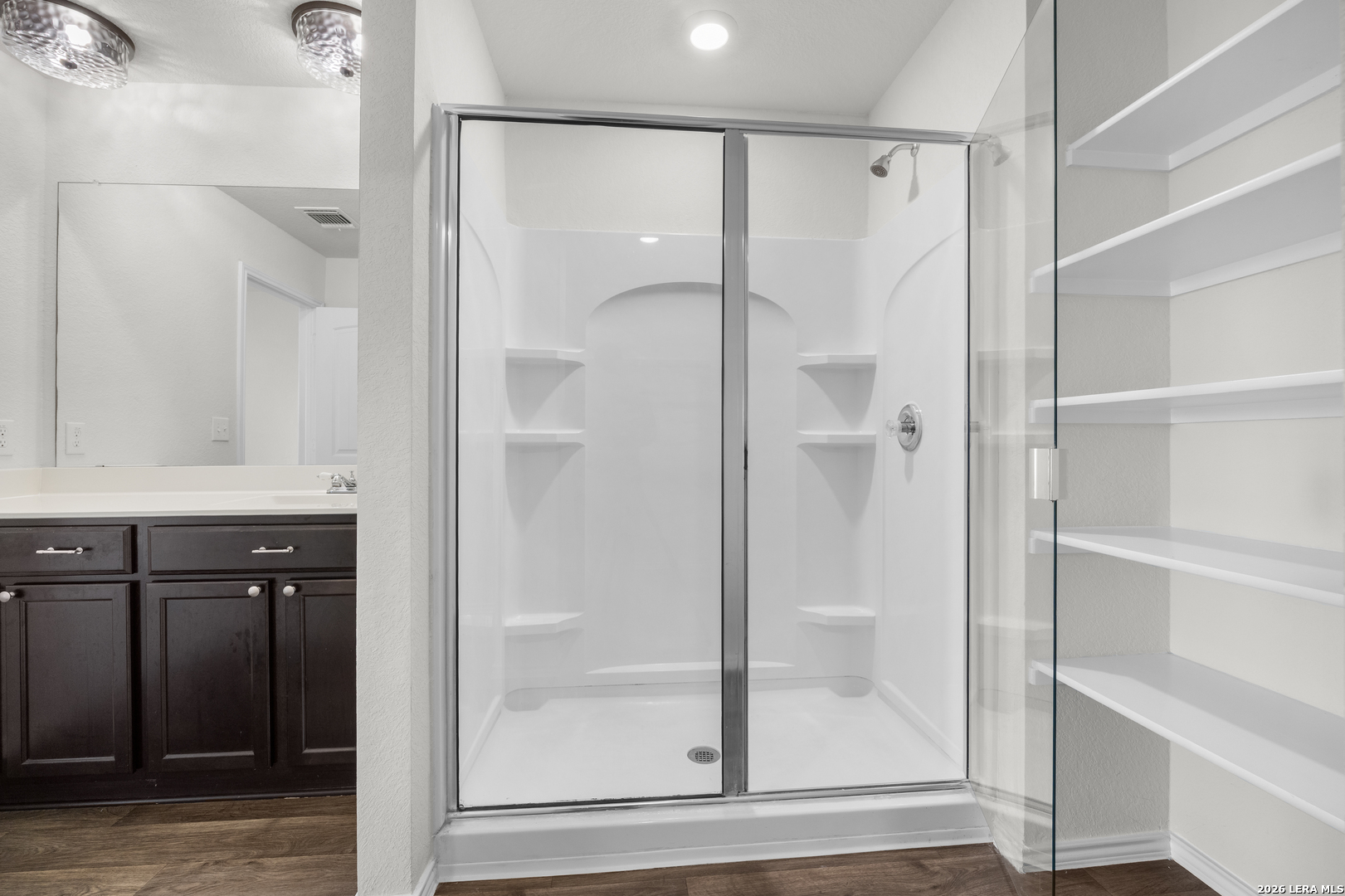 14809 Bajada Road Manor, TX 78653 - Photo 18 of 30 a bathroom with a shower and a glass door