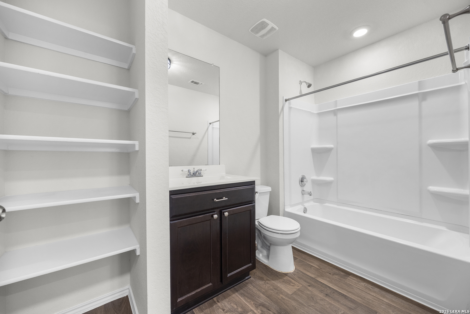 14809 Bajada Road Manor, TX 78653 - Photo 24 of 30 a bathroom with a sink a toilet a shower and a mirror